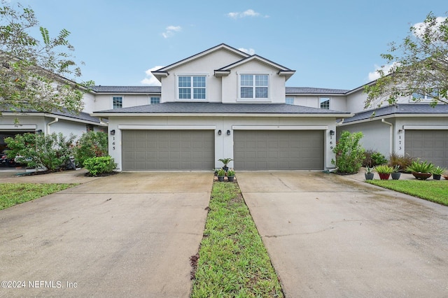 165 Amistad Dr, Saint Augustine, FL 32086 - traditional-style house with stucco siding, concrete driveway, and a garage