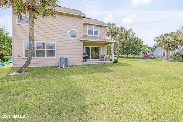 rear view of property featuring cooling unit, a patio, and a shingled roof