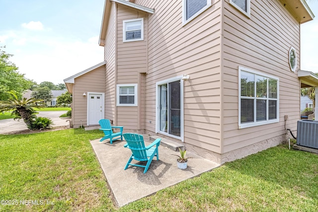 back of property featuring a lawn, a patio, and central AC