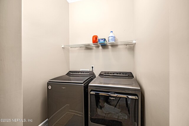 washroom featuring washer and clothes dryer