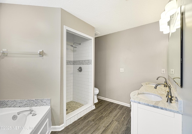 full bath with a stall shower, wood finished floors, toilet, and baseboards