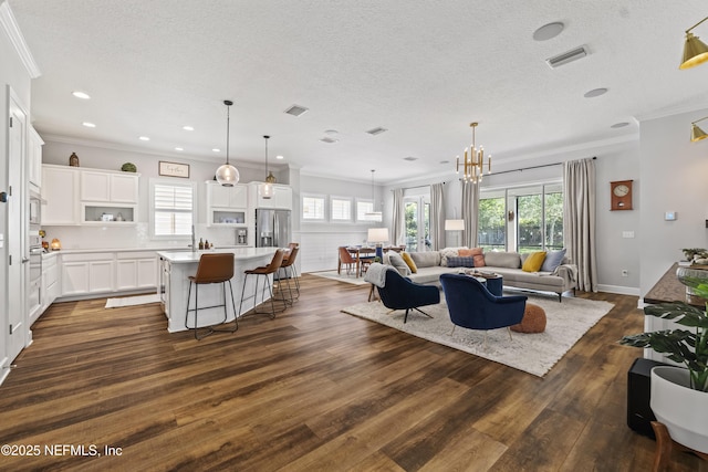 131 Seabrook Dr, Ponte Vedra, FL 32081 - living area featuring dark wood finished floors, ornamental molding, a textured ceiling, a chandelier, and recessed lighting