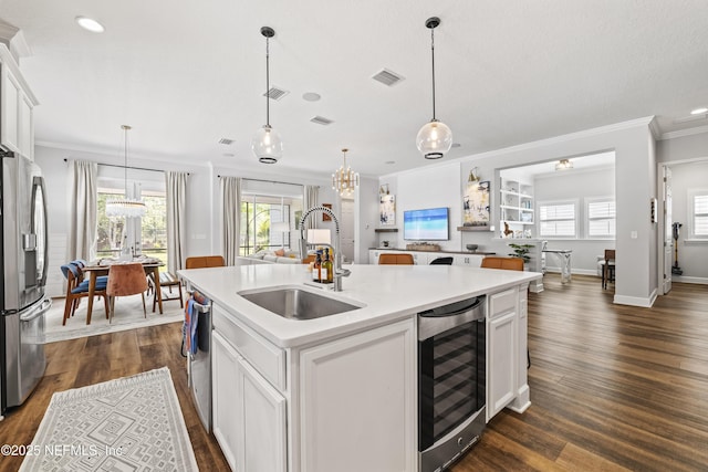 131 Seabrook Dr, Ponte Vedra, FL 32081 - kitchen featuring stainless steel appliances, wine cooler, a sink, an island with sink, and ornamental molding