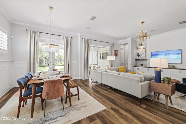 131 Seabrook Dr, Ponte Vedra, FL 32081 - dining area featuring a chandelier, dark wood-type flooring, crown molding, a wainscoted wall, and a textured ceiling
