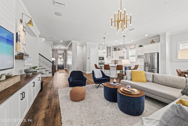 131 Seabrook Dr, Ponte Vedra, FL 32081 - living area with ornamental molding, stairway, dark wood finished floors, healthy amount of natural light, and a chandelier