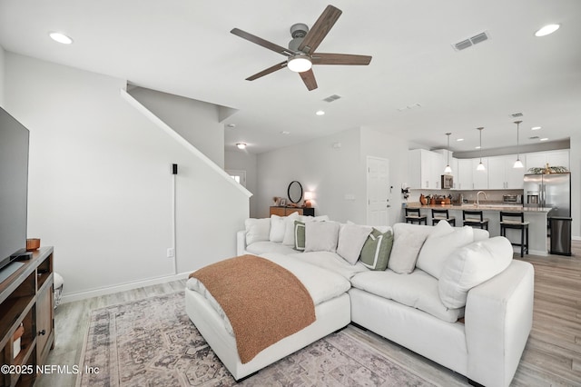 2483 Cortez Rd, Jacksonville, FL 32246 - living area featuring ceiling fan, light wood-type flooring, stairs, recessed lighting, and baseboards