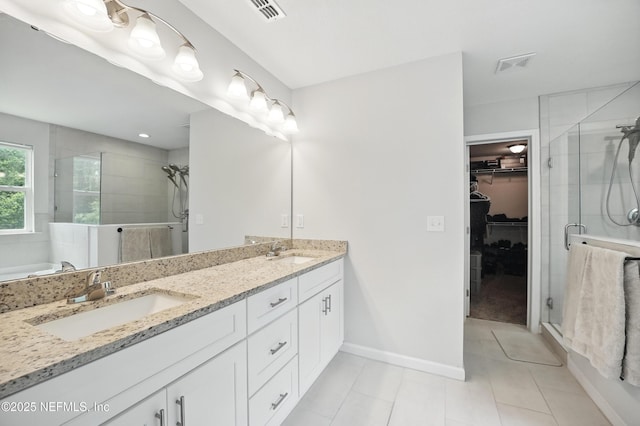 2483 Cortez Rd, Jacksonville, FL 32246 - bathroom featuring a stall shower, tile patterned floors, double vanity, and a walk in closet