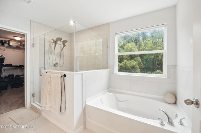2483 Cortez Rd, Jacksonville, FL 32246 - full bath featuring a shower stall, a garden tub, a walk in closet, and tile patterned flooring