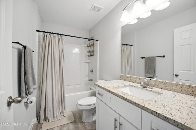 2483 Cortez Rd, Jacksonville, FL 32246 - bathroom with wood finished floors, toilet, vanity, and shower / bath combo with shower curtain
