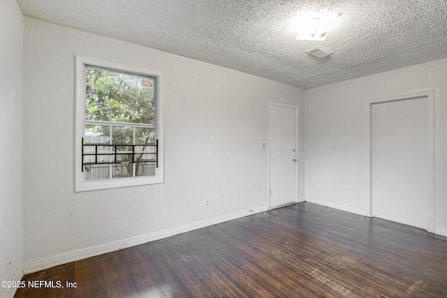 330 W 26th St, Jacksonville, FL 32206 - empty room featuring dark wood-style floors, baseboards, and a textured ceiling