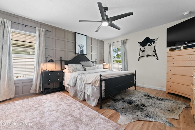 4328 Packer Meadow Way, Middleburg, FL 32068 - bedroom with wood finished floors, ceiling fan, baseboards, and a decorative wall