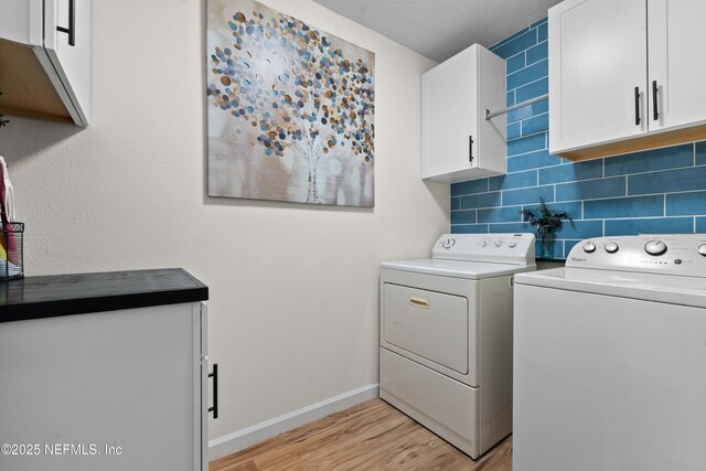 4328 Packer Meadow Way, Middleburg, FL 32068 - laundry room with washing machine and dryer, cabinet space, light wood-style flooring, and baseboards