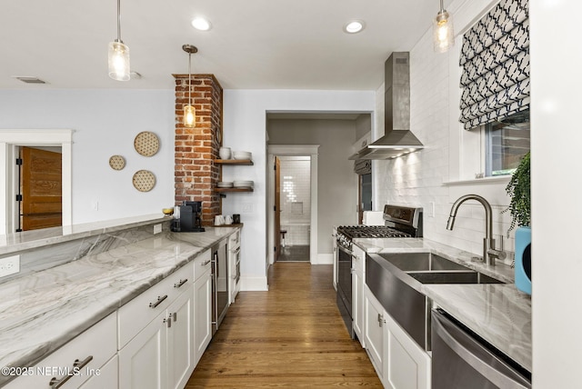 206 Cabeza St, Saint Augustine, FL 32080 - kitchen featuring appliances with stainless steel finishes, wall chimney exhaust hood, white cabinetry, light stone countertops, and recessed lighting