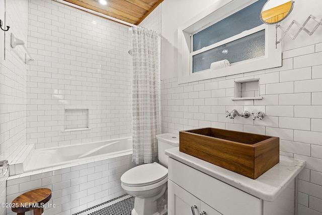 206 Cabeza St, Saint Augustine, FL 32080 - bathroom with tile walls, toilet, tiled shower / bath, tile patterned flooring, and vanity