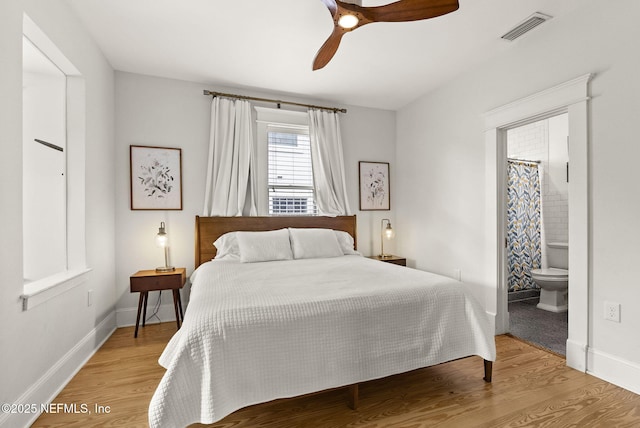 206 Cabeza St, Saint Augustine, FL 32080 - bedroom featuring light wood-style floors, baseboards, ensuite bath, and a ceiling fan