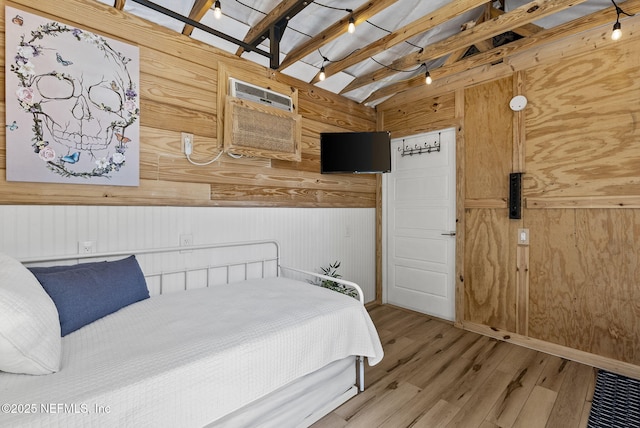 206 Cabeza St, Saint Augustine, FL 32080 - bedroom with wooden walls, lofted ceiling, wood finished floors, and a wall mounted air conditioner