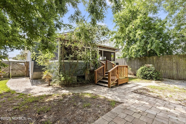 206 Cabeza St, Saint Augustine, FL 32080 - back of house with a fenced backyard, a patio, a gate, and a sunroom