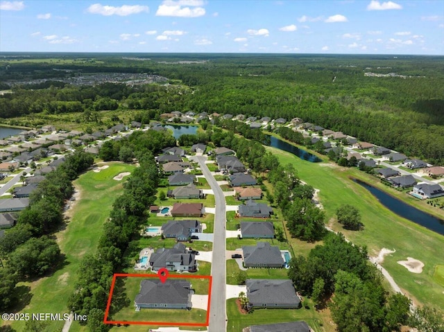 aerial view of residential area featuring a forest, property boundaries highlighted, a nearby body of water, and a golf course