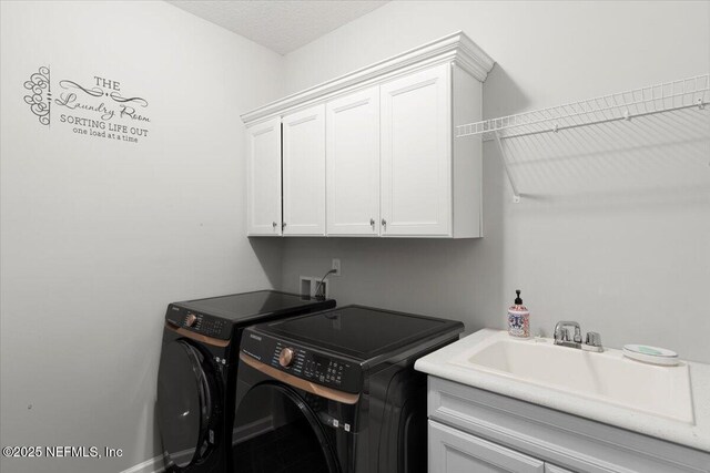 clothes washing area with cabinet space, independent washer and dryer, and baseboards