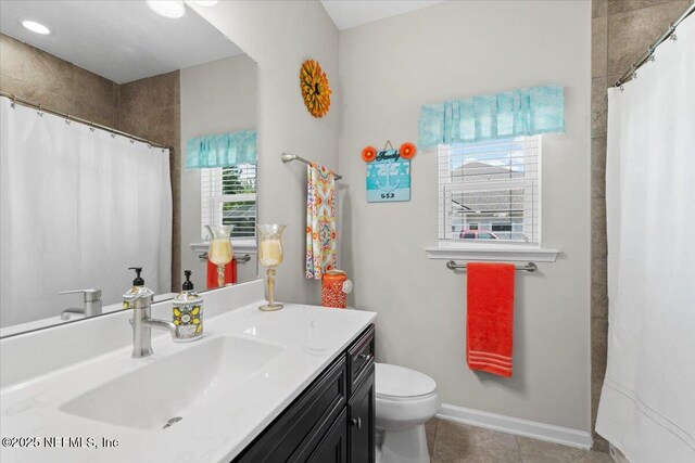 bathroom featuring toilet, vanity, tile patterned floors, and a shower with shower curtain