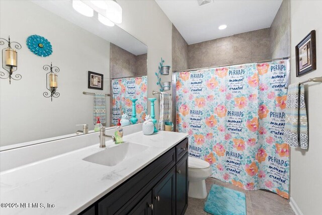 bathroom with toilet, vanity, and a shower with shower curtain
