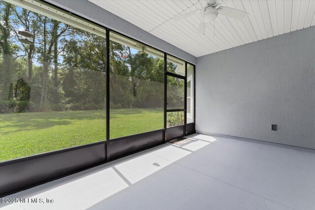 unfurnished sunroom featuring ceiling fan
