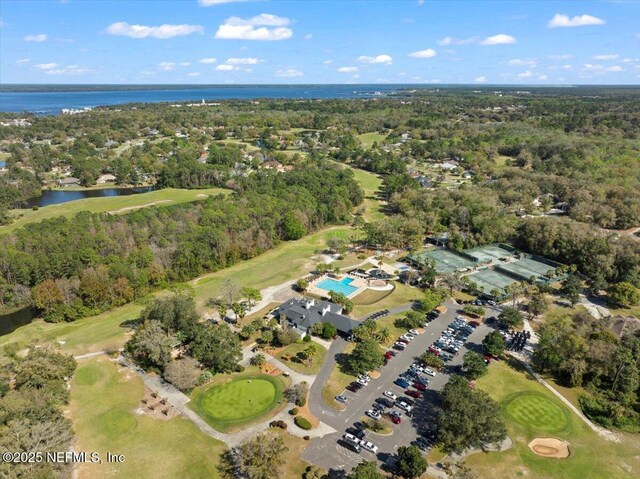 aerial overview of property's location with a large body of water, a local golf course, and a forest