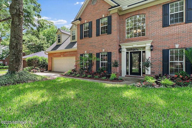 11921 Loretto Square Dr S, Jacksonville, FL 32223 - colonial inspired home with brick siding, a front yard, and an attached garage