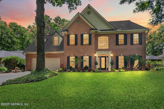 11921 Loretto Square Dr S, Jacksonville, FL 32223 - colonial house featuring brick siding, a front yard, driveway, and a garage
