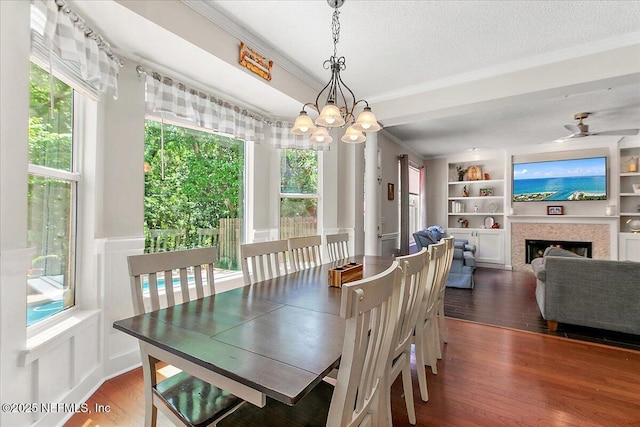 11921 Loretto Square Dr S, Jacksonville, FL 32223 - dining room with ornamental molding, a chandelier, wood finished floors, built in features, and a decorative wall