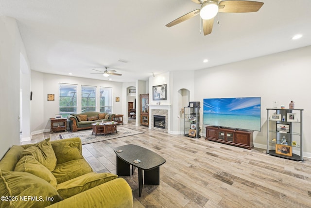 1009 Welaka Way, Saint Augustine, FL 32092 - living room featuring ceiling fan, light wood-style flooring, a glass covered fireplace, recessed lighting, and baseboards
