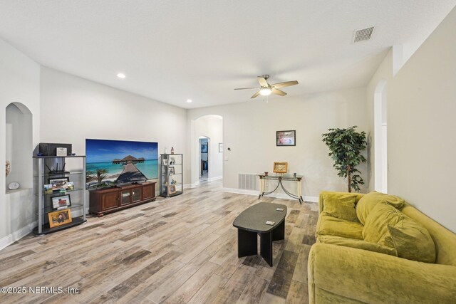 1009 Welaka Way, Saint Augustine, FL 32092 - living area featuring arched walkways, a ceiling fan, wood finished floors, recessed lighting, and baseboards