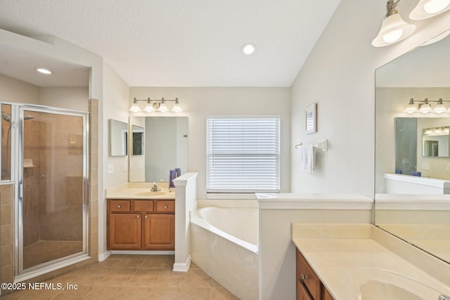 1009 Welaka Way, Saint Augustine, FL 32092 - full bath featuring a stall shower, tile patterned floors, a bath, two vanities, and recessed lighting
