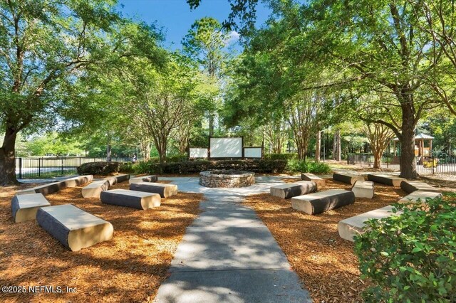 1009 Welaka Way, Saint Augustine, FL 32092 - view of property's community featuring a fire pit, fence, and view of wooded area