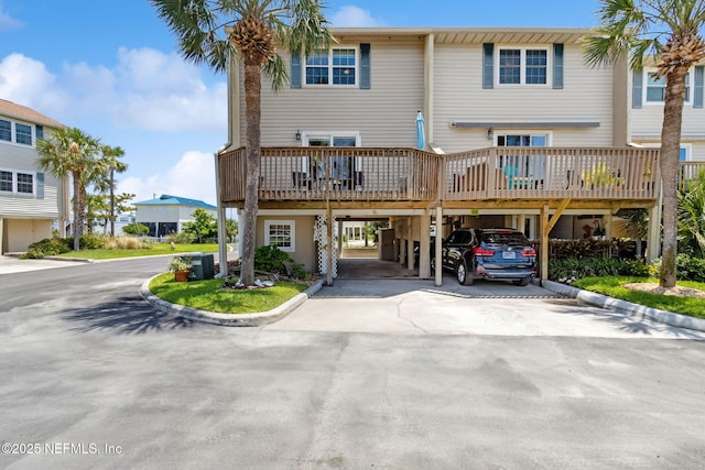 925 Tarpon Ave Unit 16, Fernandina Beach, FL 32034 - rear view of house featuring driveway, a carport, central AC unit, and a wooden deck