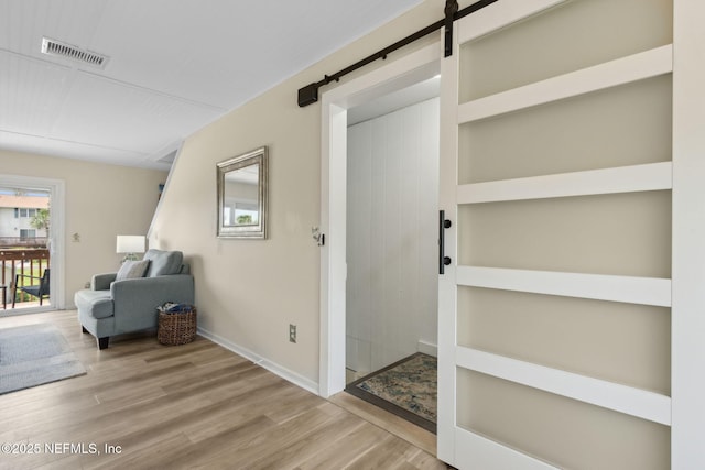 925 Tarpon Ave Unit 16, Fernandina Beach, FL 32034 - interior space featuring wood finished floors, a barn door, and baseboards