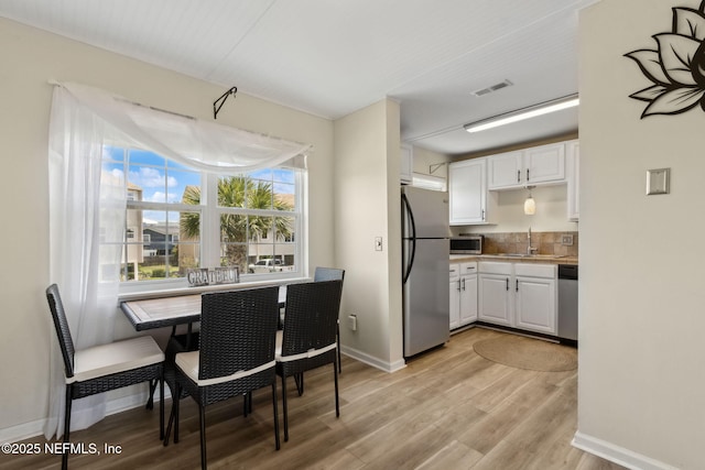 925 Tarpon Ave Unit 16, Fernandina Beach, FL 32034 - dining space with light wood finished floors and baseboards