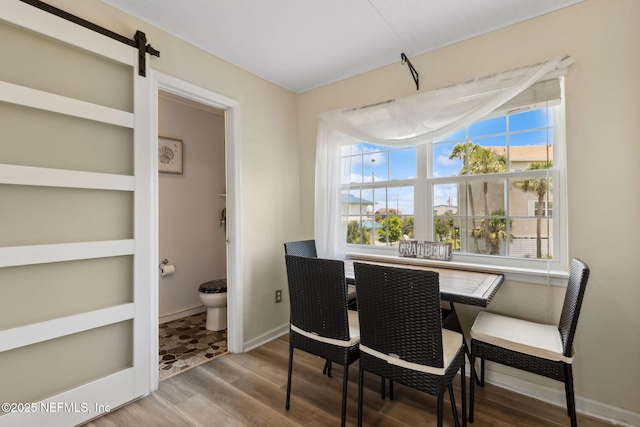 925 Tarpon Ave Unit 16, Fernandina Beach, FL 32034 - dining room with wood finished floors, baseboards, and a barn door