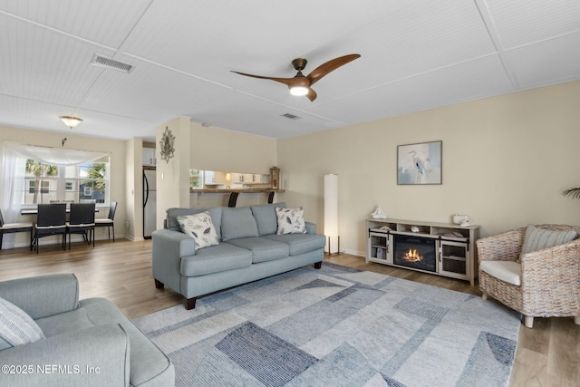 925 Tarpon Ave Unit 16, Fernandina Beach, FL 32034 - living area featuring wood finished floors, ceiling fan, baseboards, and a glass covered fireplace
