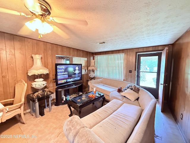 4507 Harbor View Dr, Jacksonville, FL 32208 - living area with wood walls, a textured ceiling, and a ceiling fan