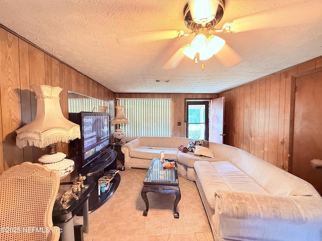 4507 Harbor View Dr, Jacksonville, FL 32208 - living area featuring wooden walls, a textured ceiling, and a ceiling fan