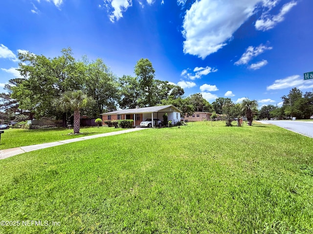 4507 Harbor View Dr, Jacksonville, FL 32208 - view of front of home with a front yard, driveway, and an attached carport