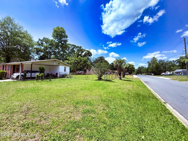 4507 Harbor View Dr, Jacksonville, FL 32208 - view of green lawn with an attached carport
