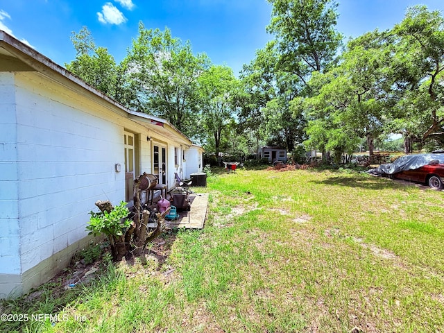 4507 Harbor View Dr, Jacksonville, FL 32208 - view of green lawn featuring french doors and a patio area