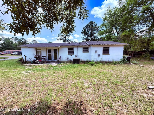 4507 Harbor View Dr, Jacksonville, FL 32208 - back of property with french doors, a yard, a patio area, concrete block siding, and cooling unit