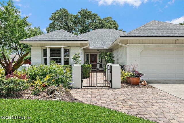73 Waterbridge Pl, Ponte Vedra Beach, FL 32082 - view of front of property with brick siding, a shingled roof, a gate, a garage, and concrete driveway