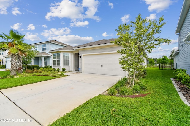 view of front facade with driveway, a front yard, and a garage