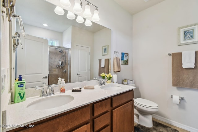 full bathroom featuring toilet, a shower stall, and double vanity