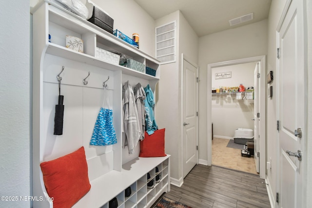 mudroom with wood finished floors and baseboards