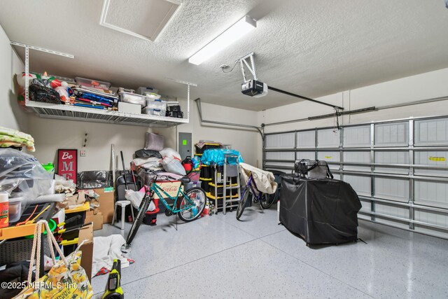 garage featuring a garage door opener and electric panel